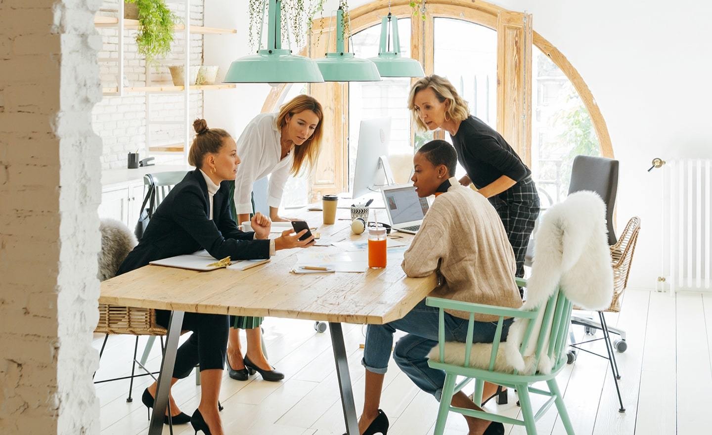 Group of female coworkers at a shared desk