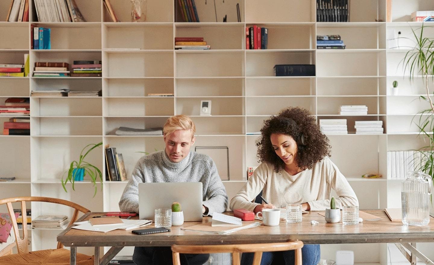 Man and women sitting behind working desk