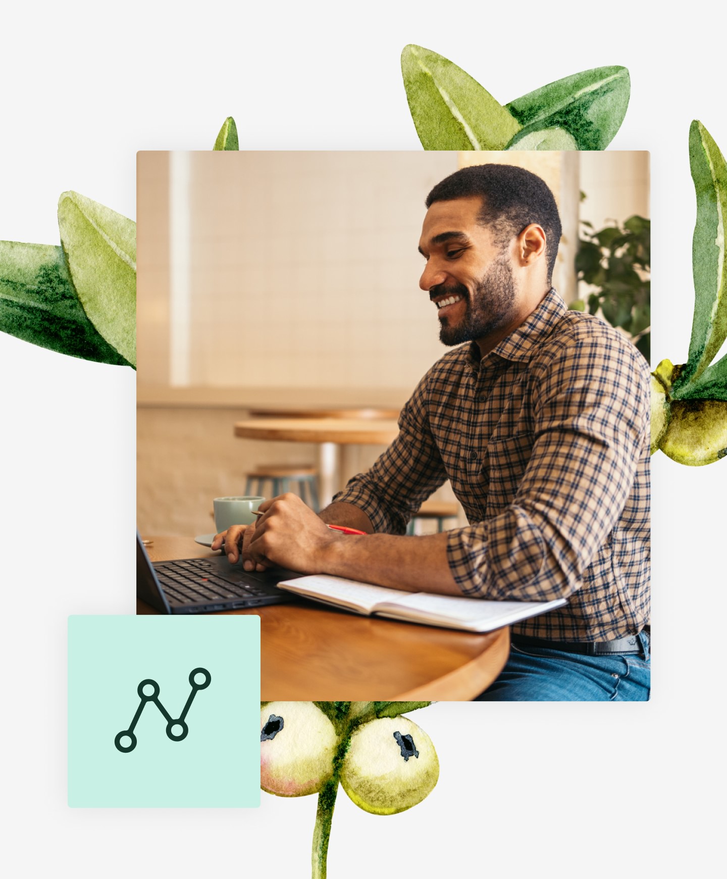 Man sitting on desk while working on laptop with a botanical plant behind