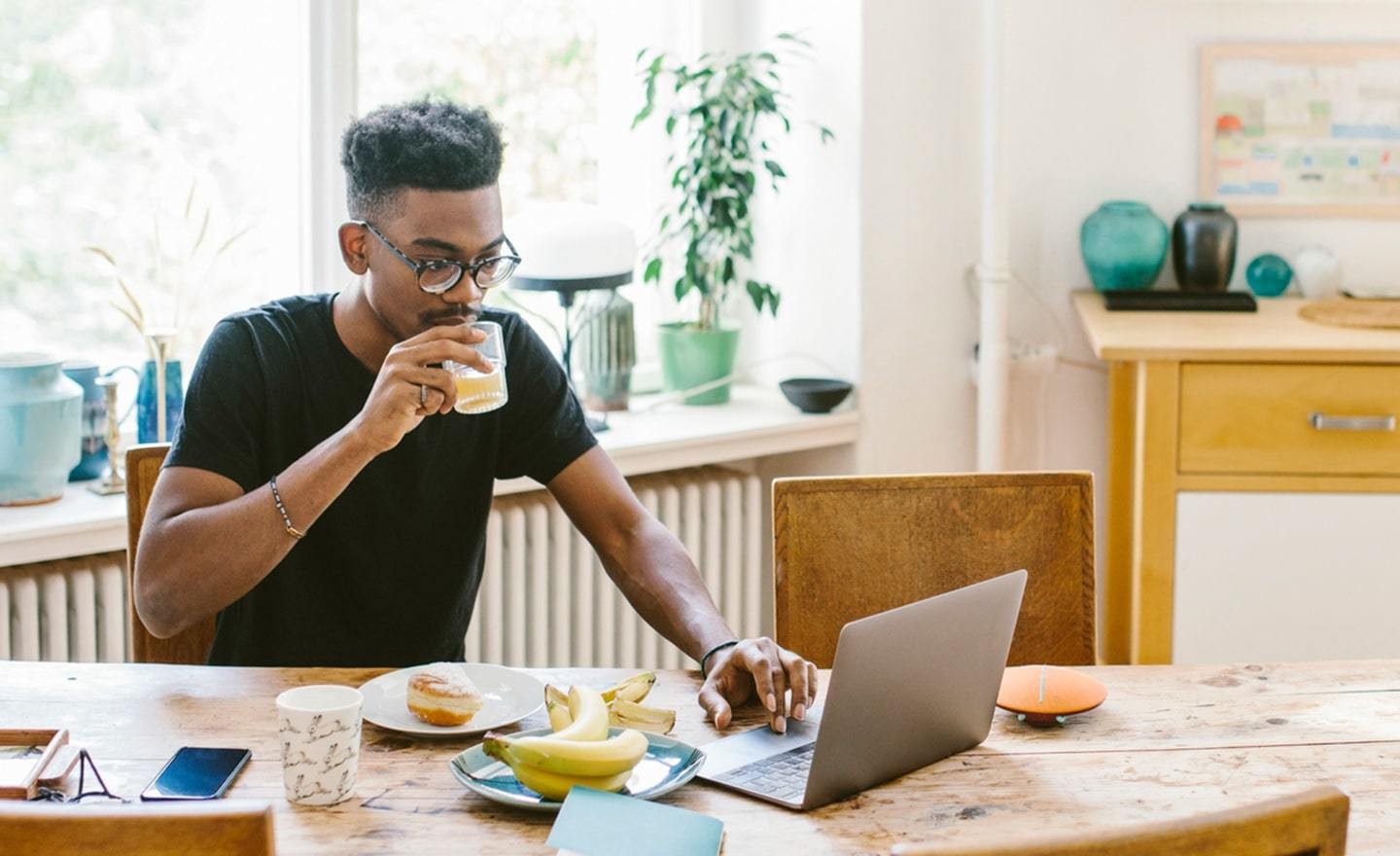 Man working on laptop in kitchen