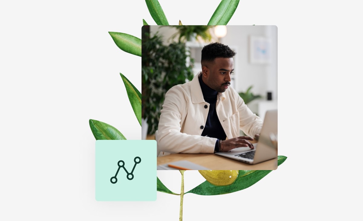 Man working on laptop with data icon and botanical plant behind