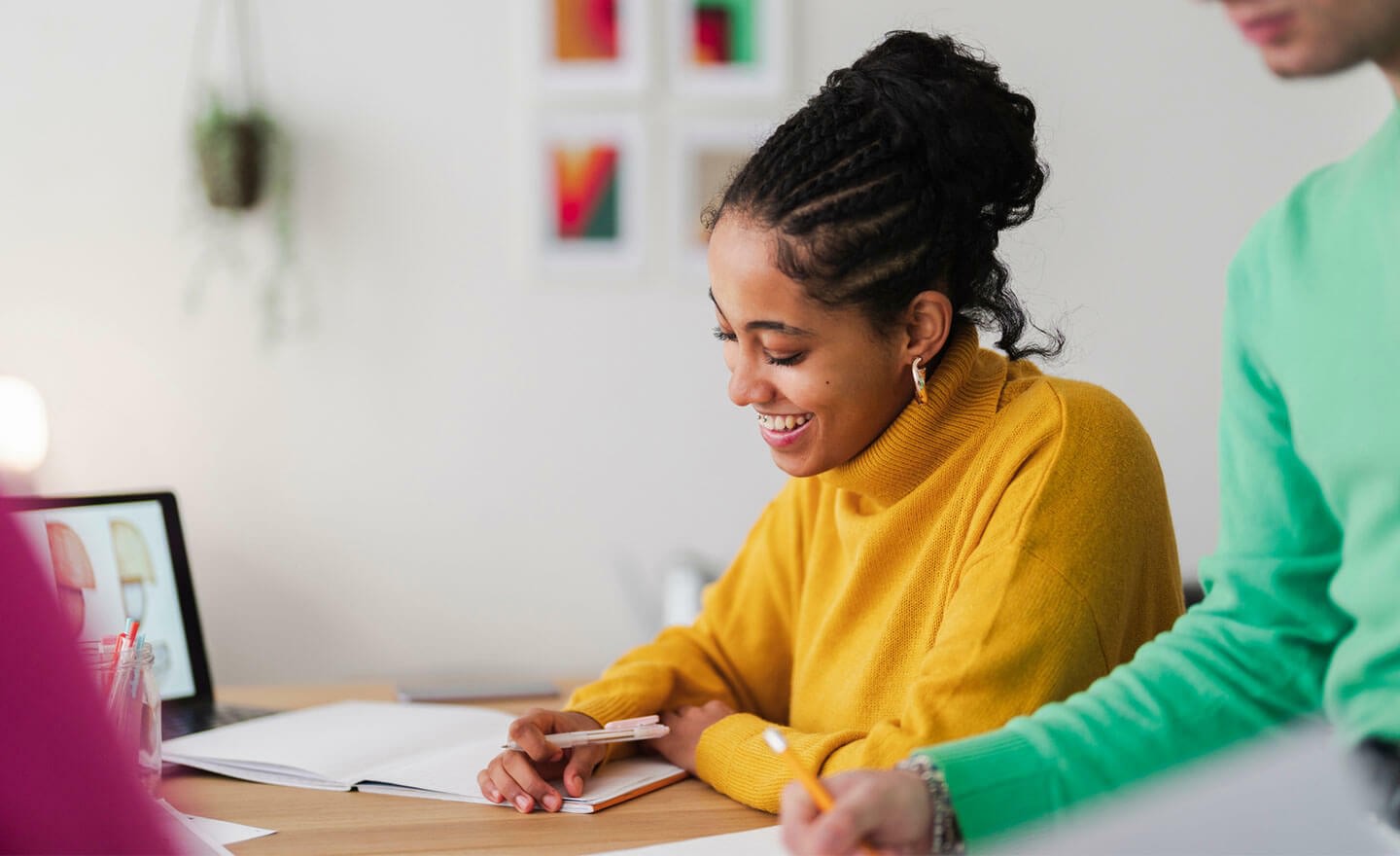 Smiling happy person at work taking notes