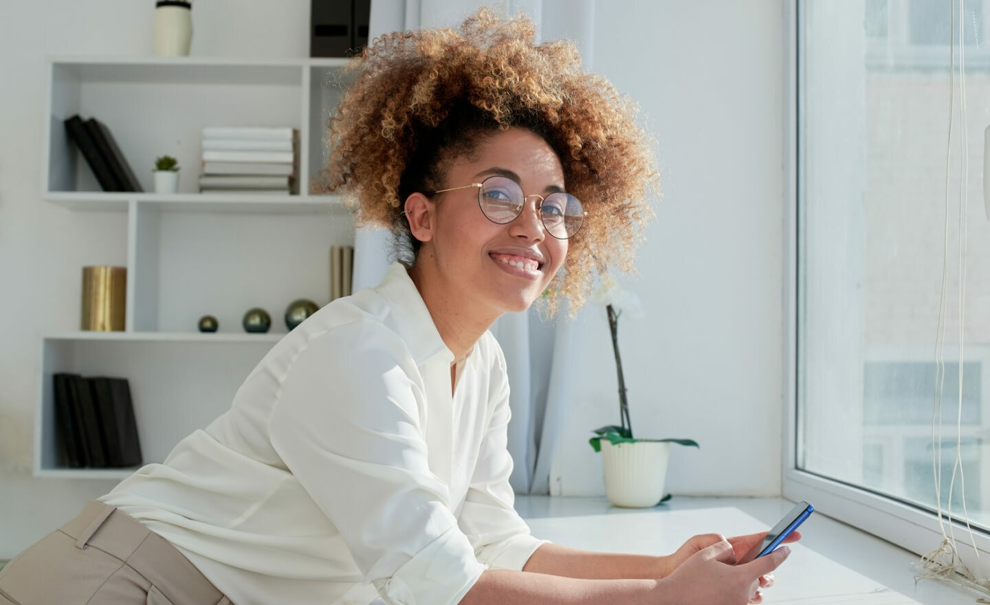 Smiling woman holding phone