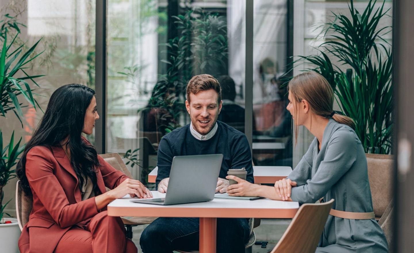 Three coworkers sitting outdoors