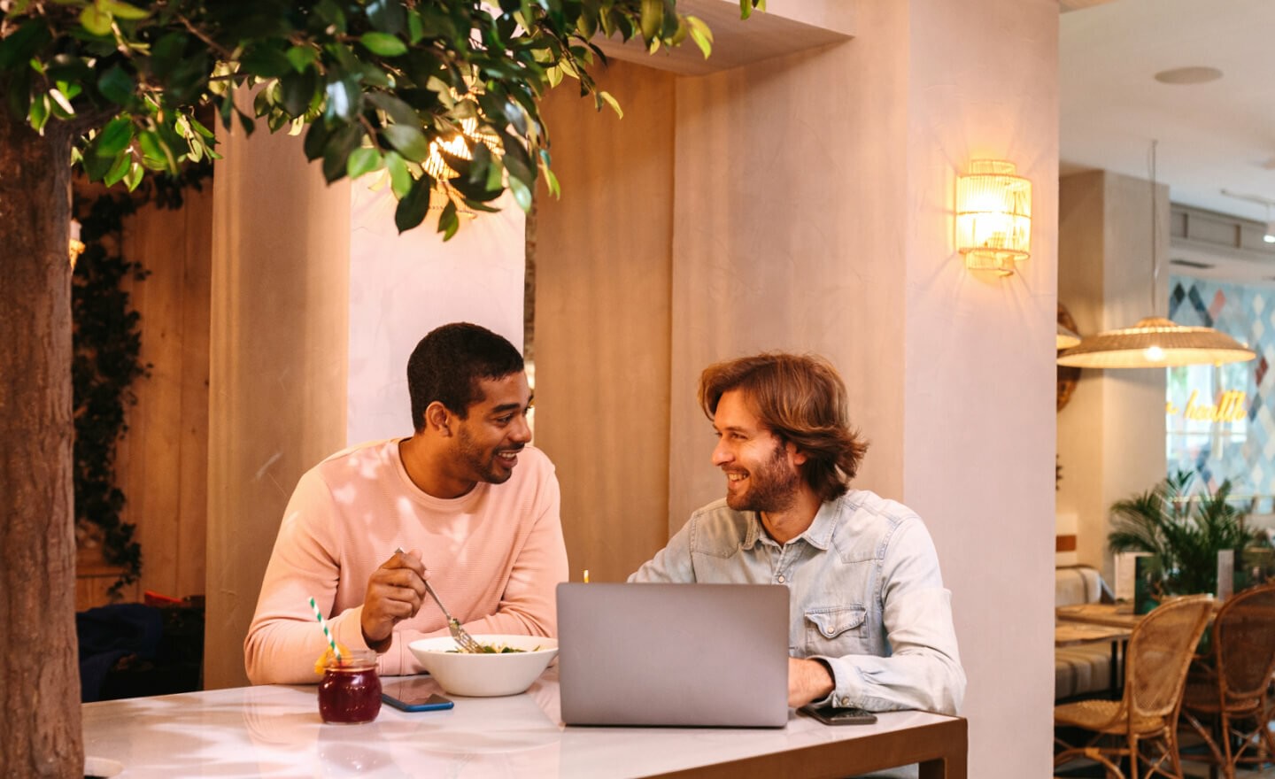 Two coworkers talking in office kitchen