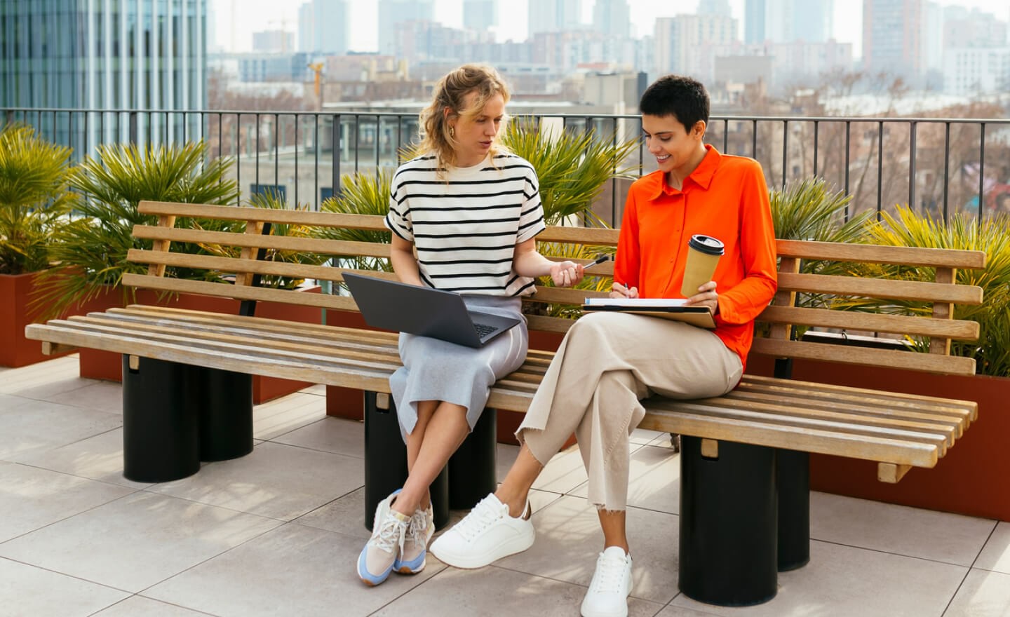 Two coworkers working on roof deck