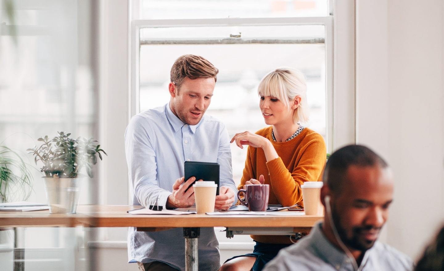 Two people talking at a standing desk