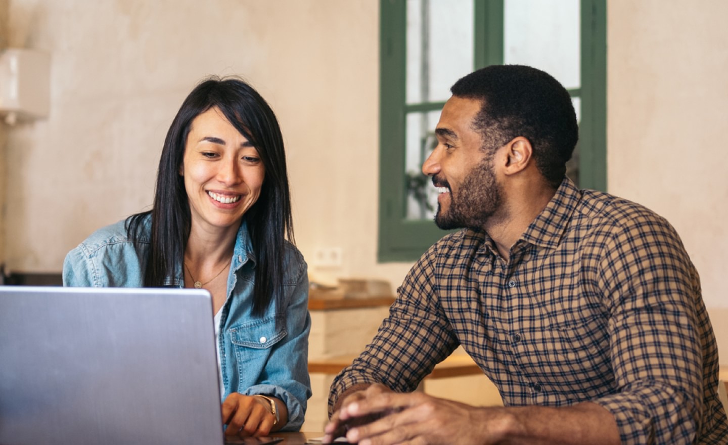 Woman and man working and looking at laptop