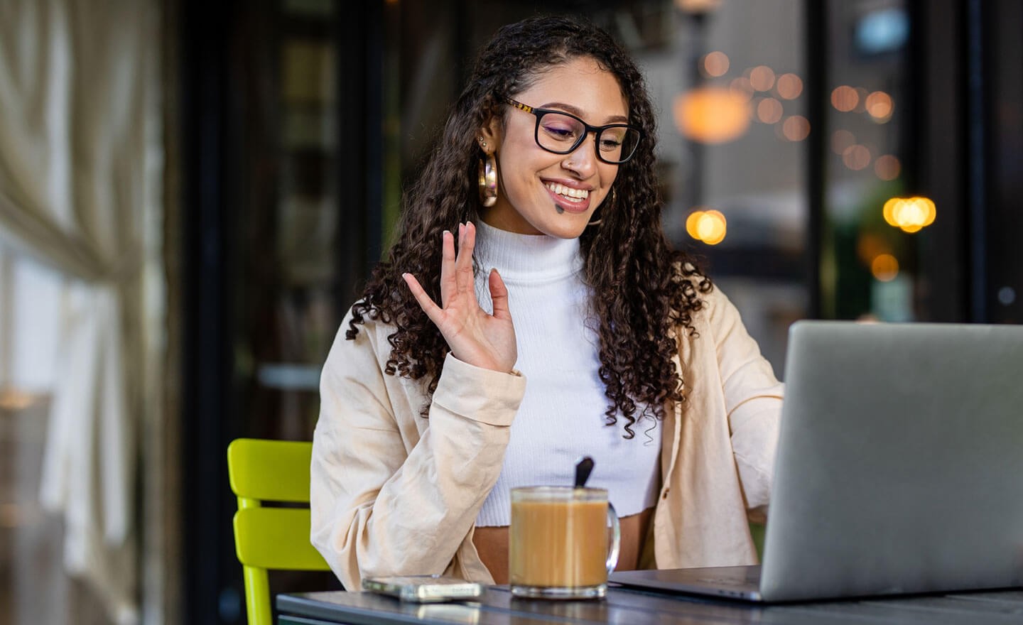 Woman on video meeting at coffee shop