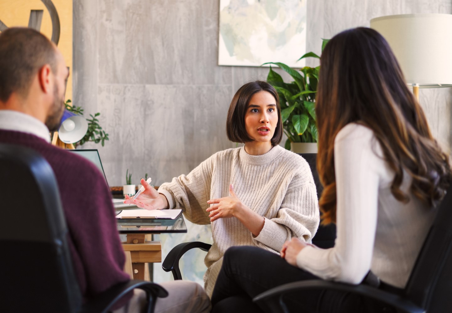 Woman talking with two colleagues