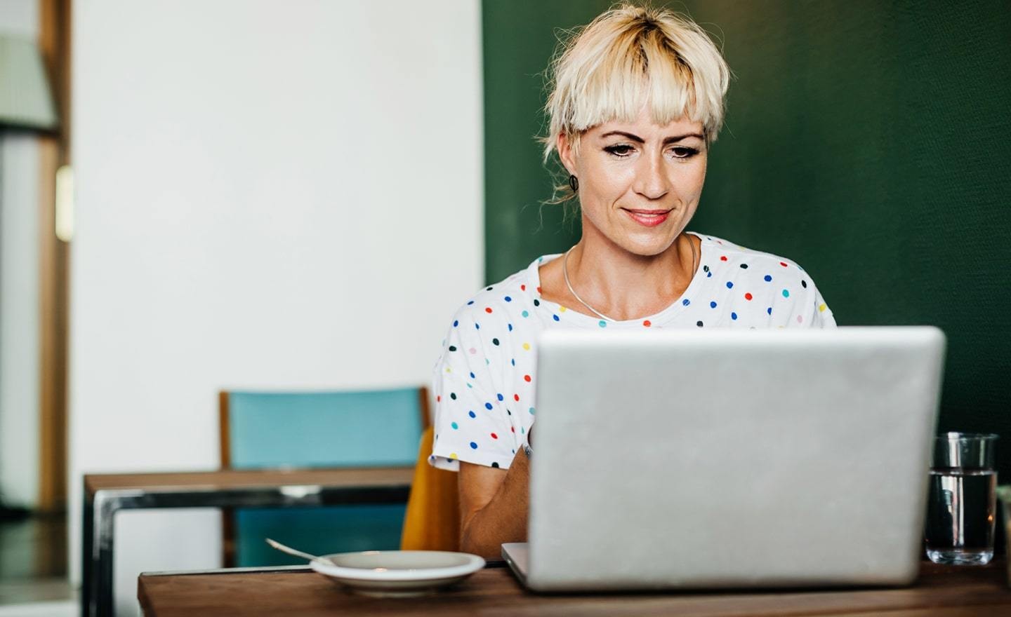 Woman working at table with laptop