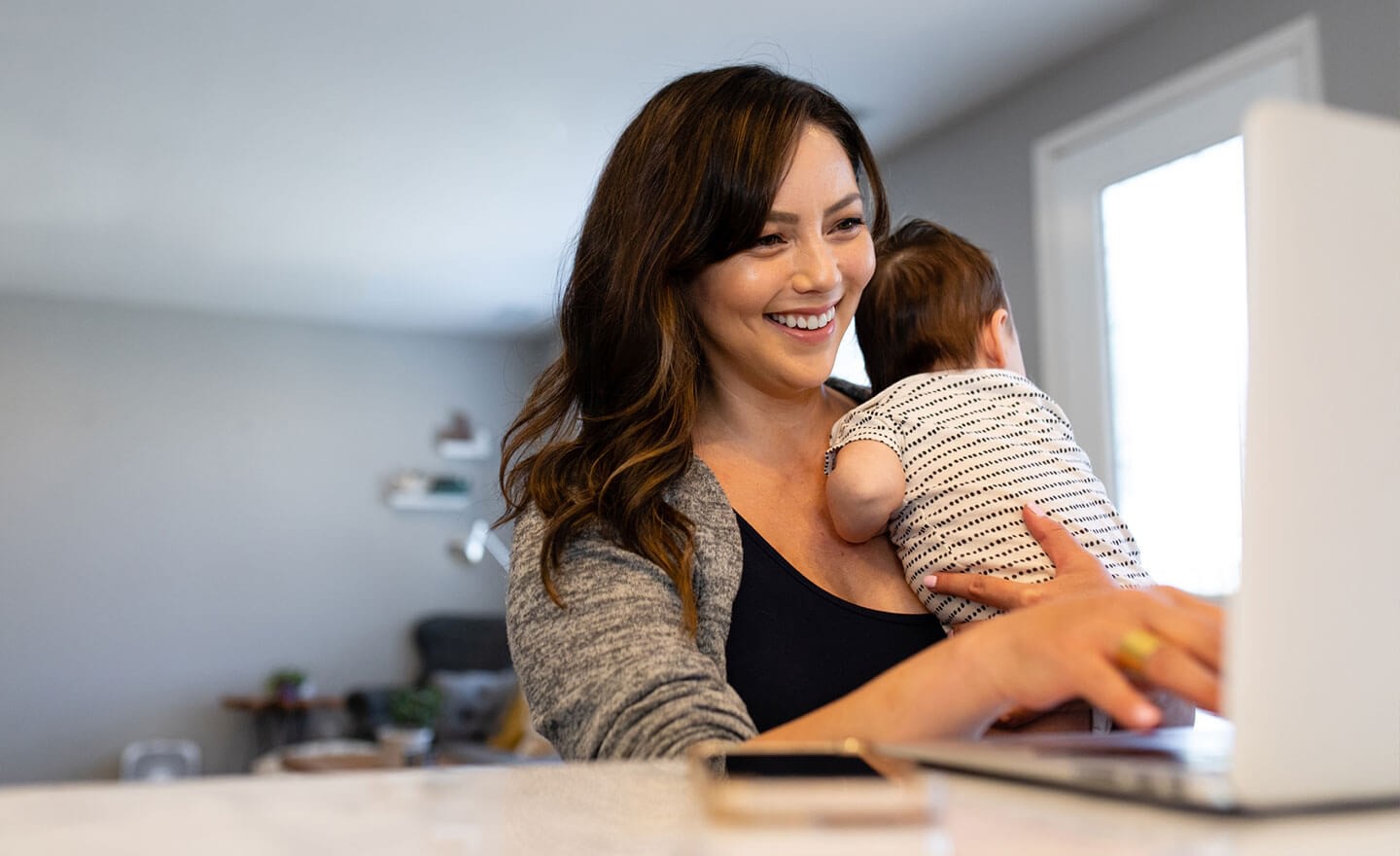 Woman working from home with baby 1