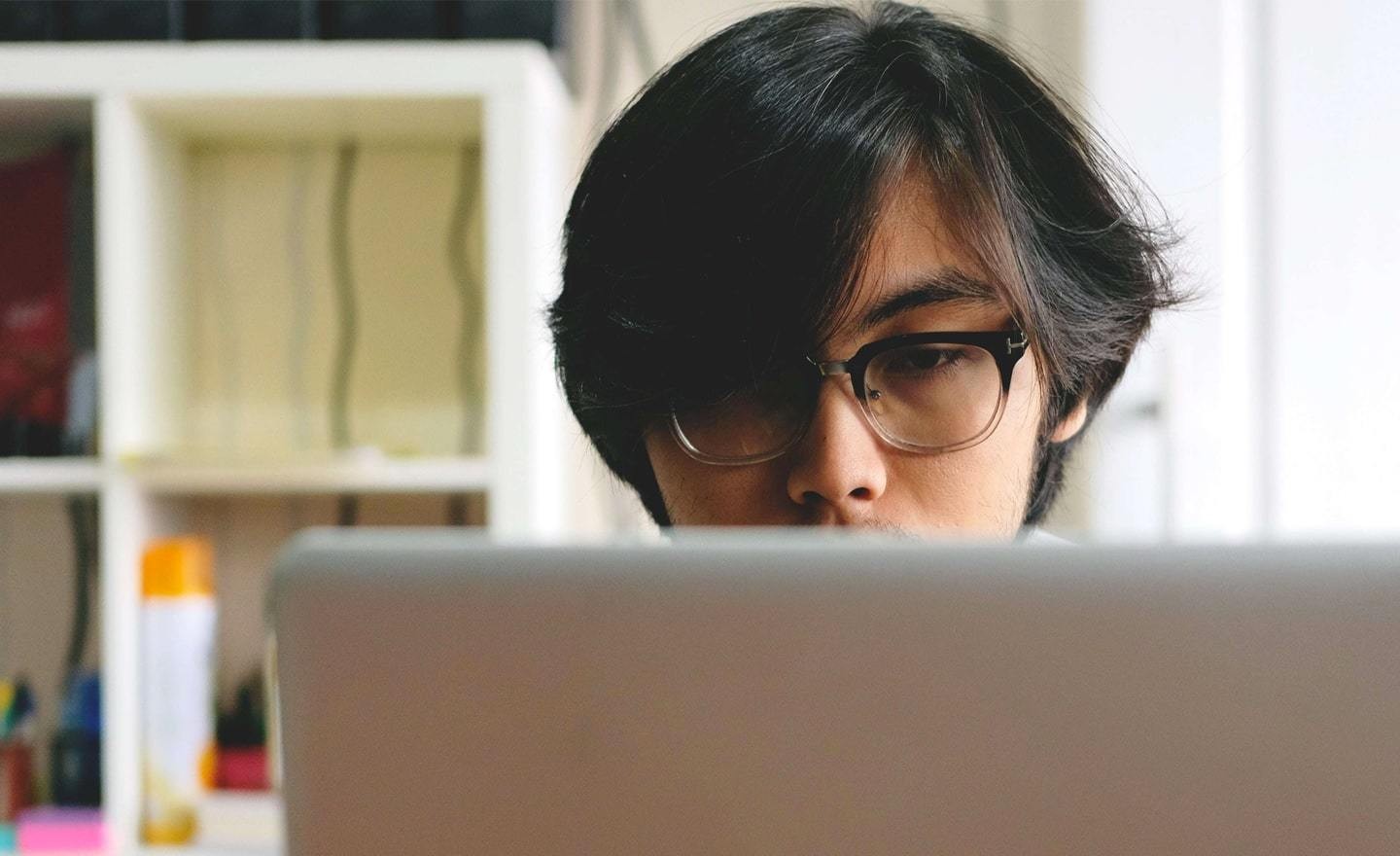 Young Asian man at a laptop