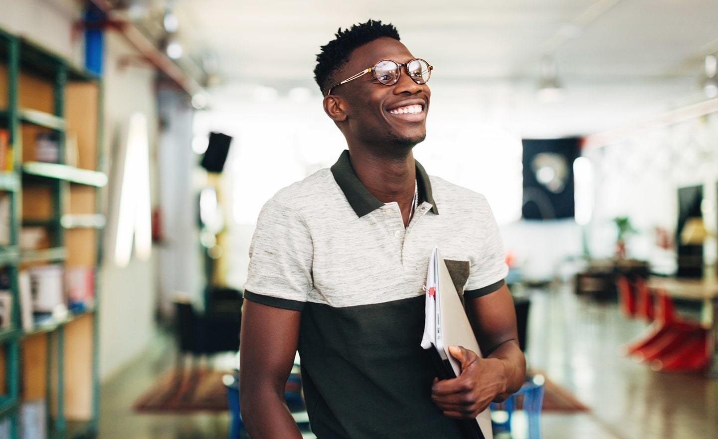 Young black man holding a notebook