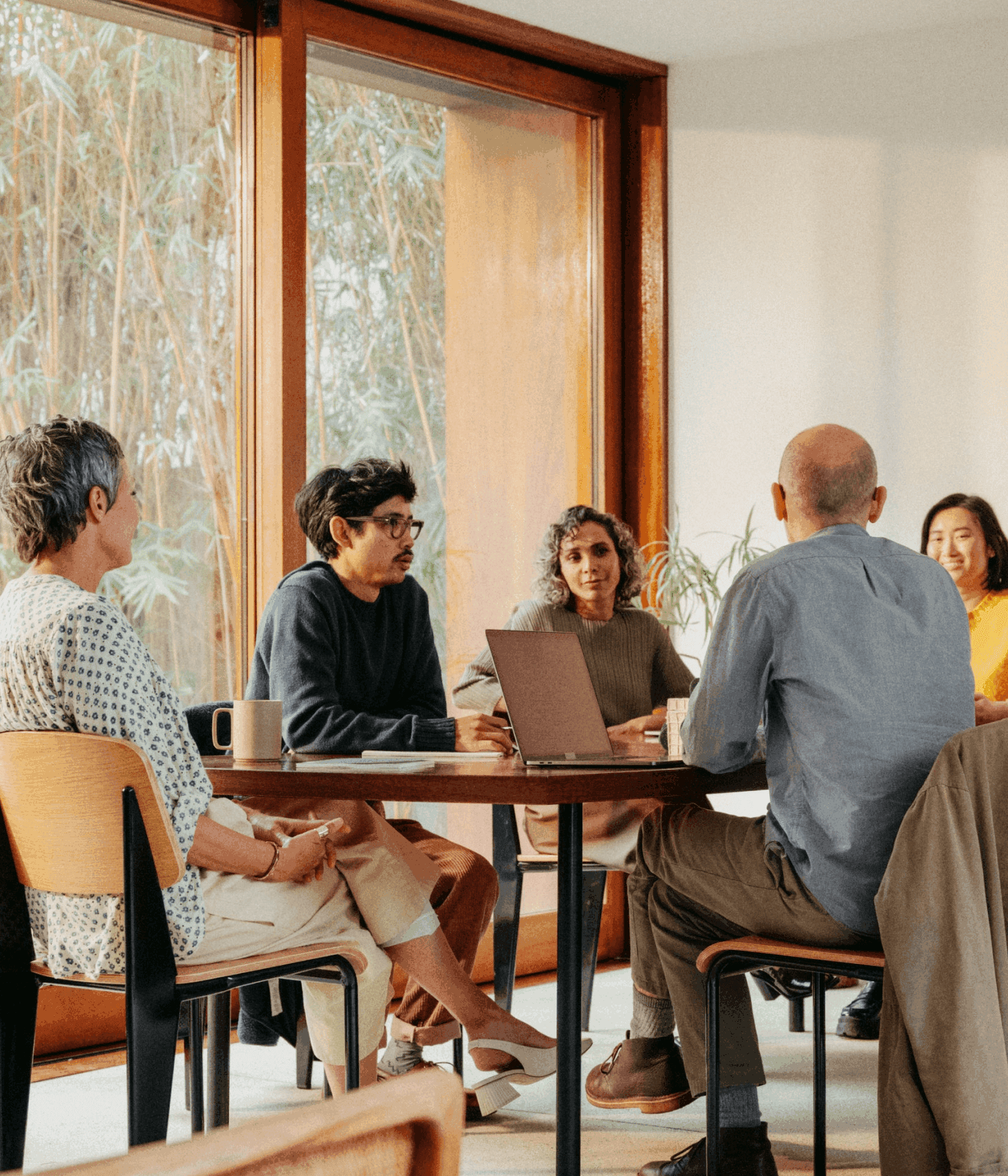 Group of coworkers in conference room warm tones