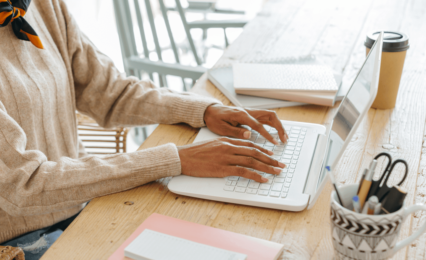 Hands typing on laptop