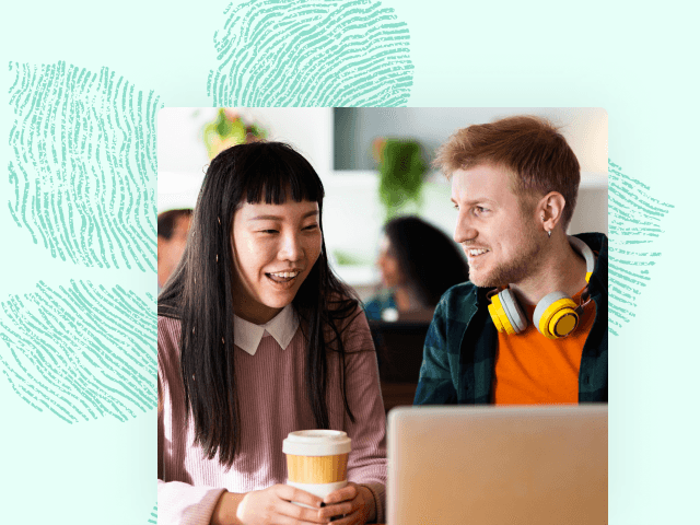 Woman and man talking while in office setting behind a laptop resource 4