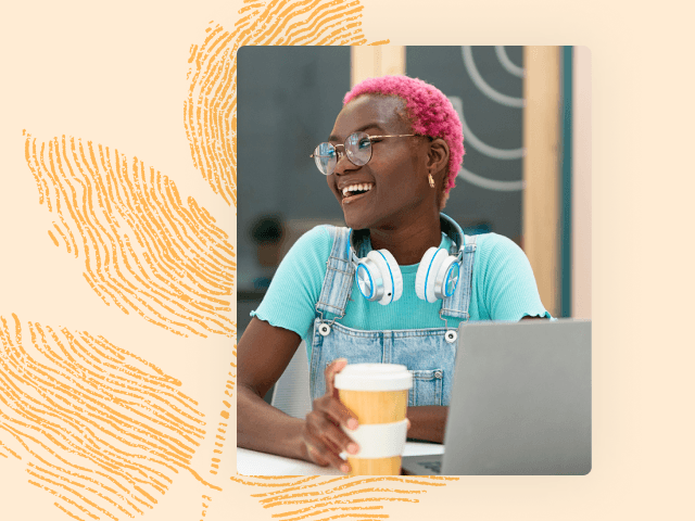 Woman smiling while sitting behind laptop resource 1