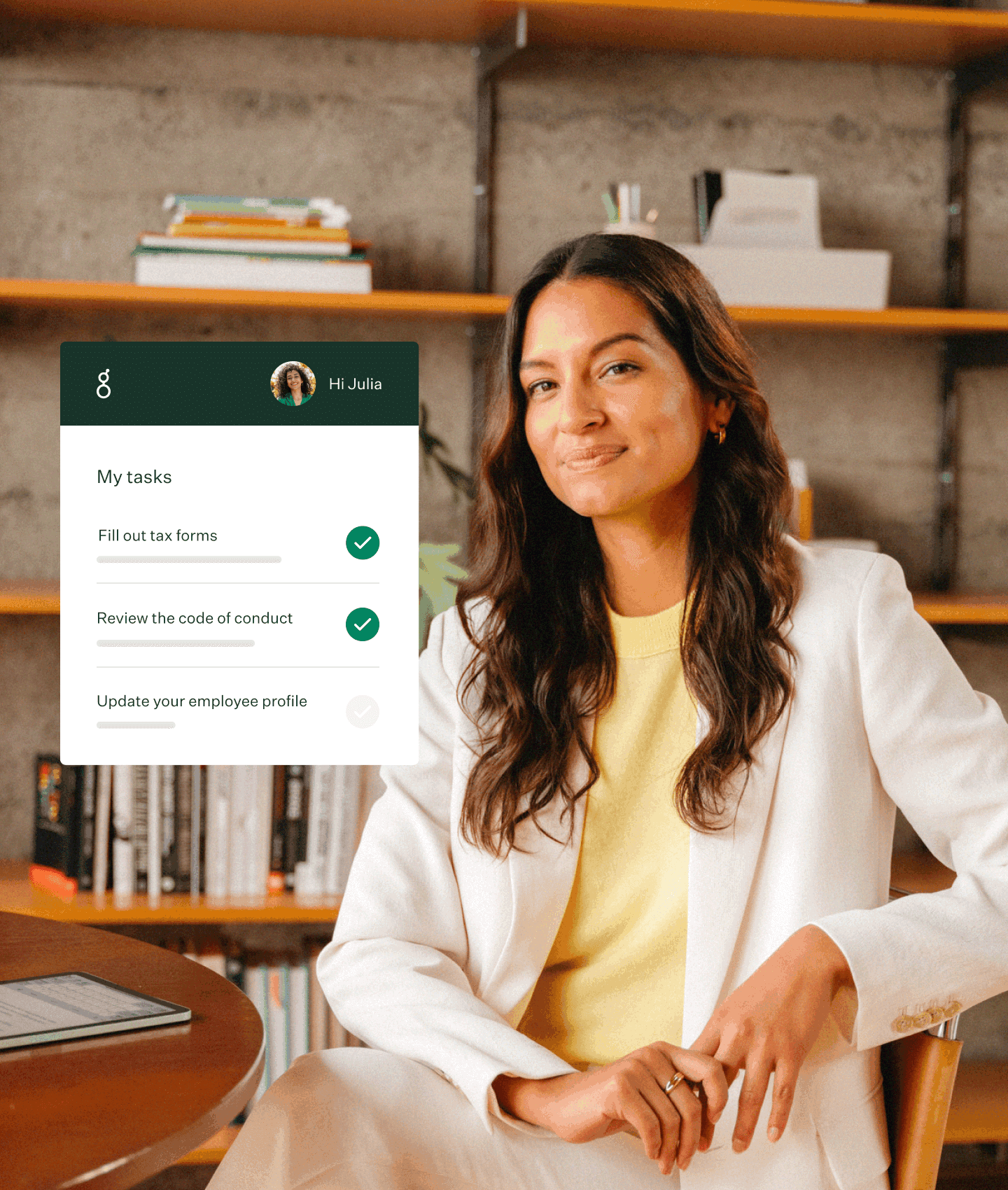 Woman wearing white suit in warm toned office with bookshelf wall and Greenhouse Onboarding UI element